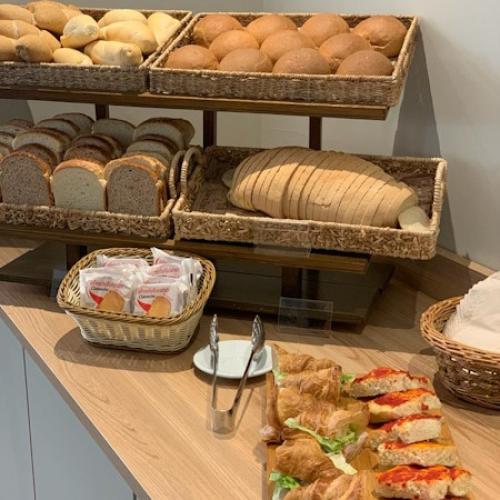 Varietà di pane e croissant farciti su un tavolo in una panetteria.